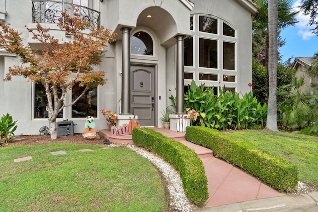 property entrance with a yard