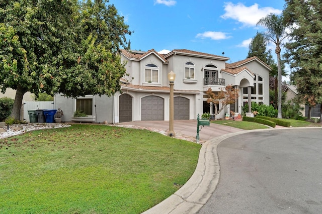 mediterranean / spanish-style house featuring a balcony, a front lawn, and a garage