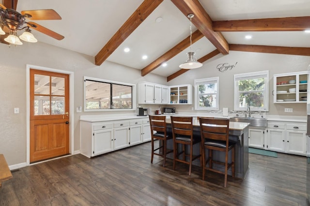 kitchen featuring white cabinetry, sink, hanging light fixtures, and dark hardwood / wood-style flooring