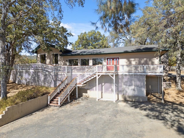 rear view of property with a wooden deck