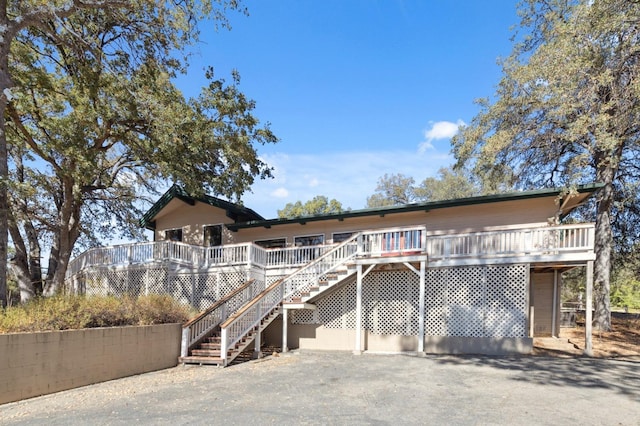 view of front facade with a wooden deck