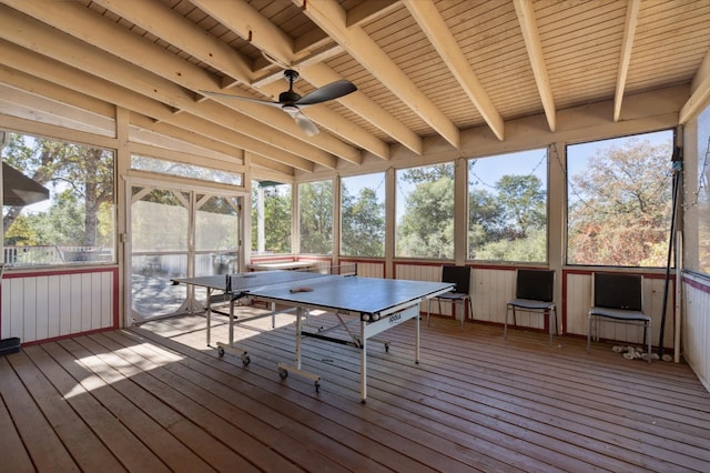 unfurnished sunroom featuring beam ceiling, wood ceiling, and ceiling fan