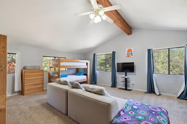 carpeted bedroom with vaulted ceiling with beams and ceiling fan