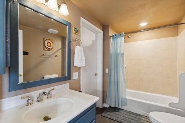 full bathroom featuring vanity, shower / bath combination with curtain, and toilet