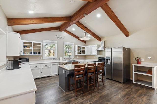 kitchen featuring vaulted ceiling with beams, wall chimney range hood, stainless steel appliances, white cabinets, and dark hardwood / wood-style flooring