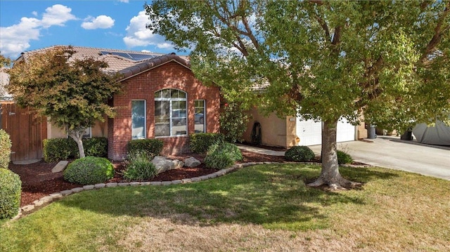 view of front of property with a garage and a front lawn