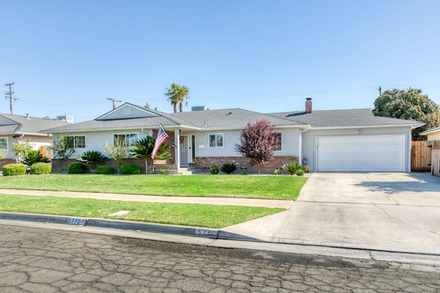 ranch-style house with a garage and a front lawn