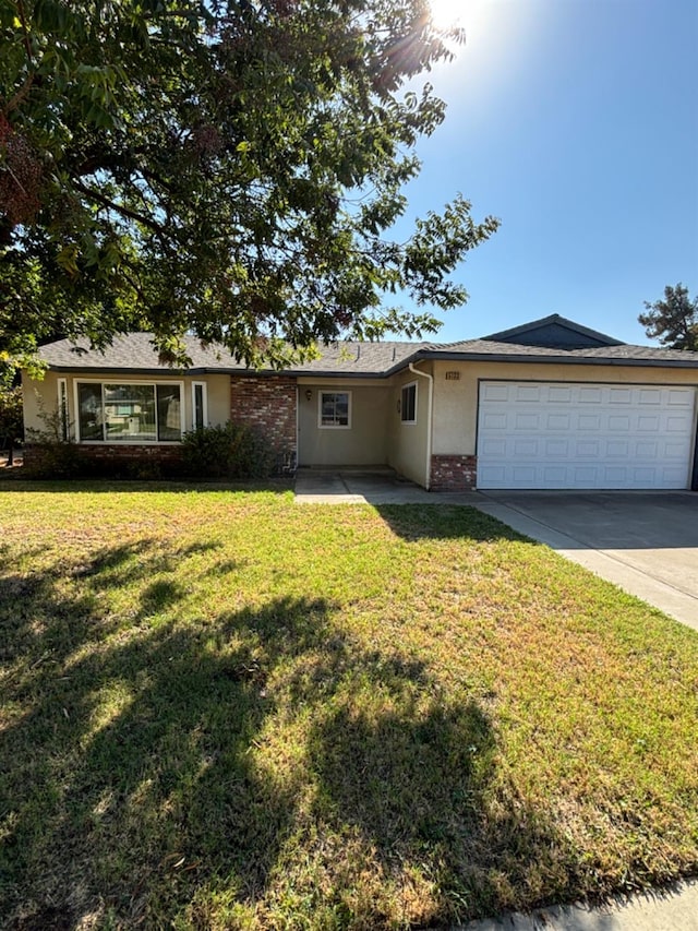 single story home with a garage and a front yard