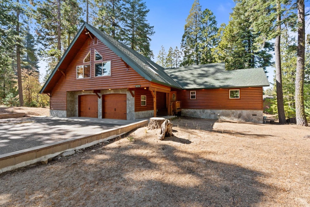 log home featuring a garage