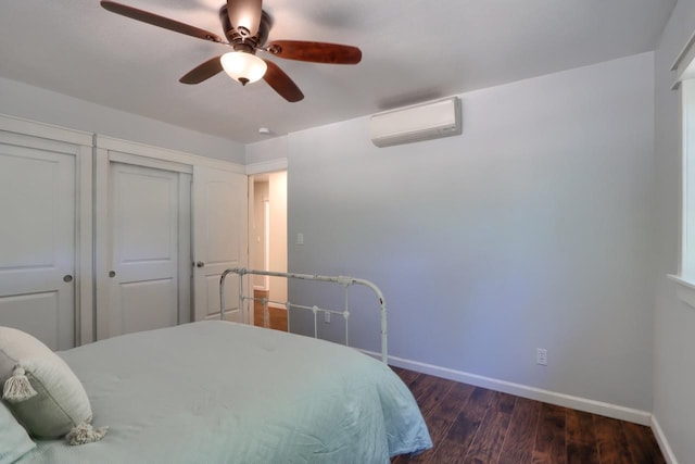 bedroom featuring ceiling fan, dark hardwood / wood-style floors, and a wall unit AC