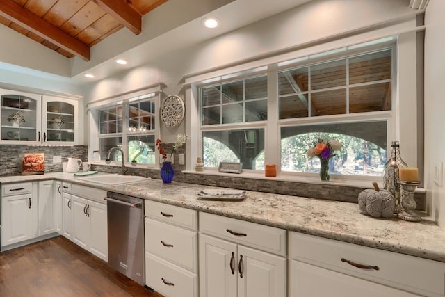 kitchen with vaulted ceiling with beams, white cabinetry, sink, and wooden ceiling