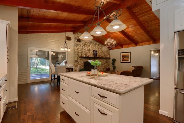 kitchen with vaulted ceiling with beams, white cabinetry, decorative light fixtures, a chandelier, and dark hardwood / wood-style floors