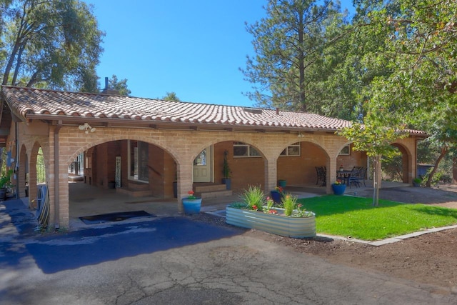 mediterranean / spanish-style home featuring a patio