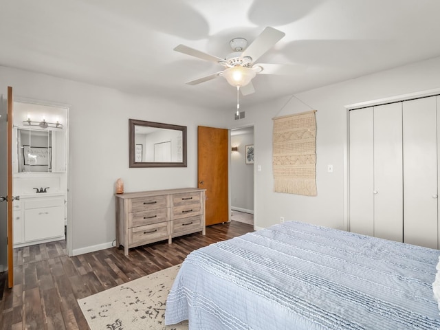bedroom with visible vents, a closet, dark wood finished floors, and baseboards