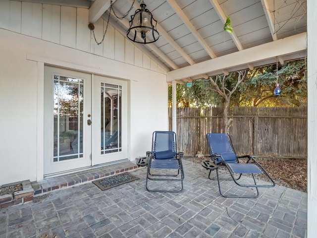 view of patio featuring fence and french doors