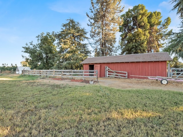 view of outdoor structure featuring fence, an outdoor structure, and an exterior structure