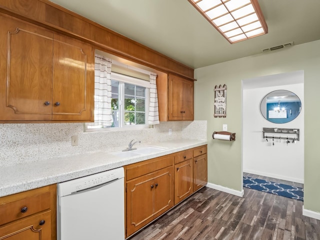 kitchen featuring a sink, dark wood-style flooring, tasteful backsplash, light countertops, and dishwasher