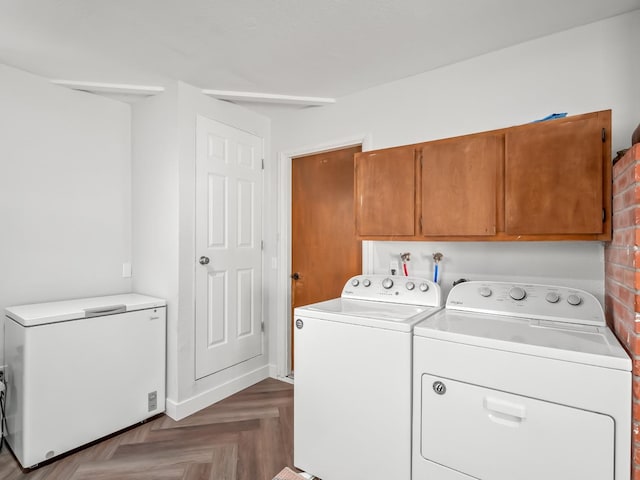 laundry room featuring washer and clothes dryer and cabinet space