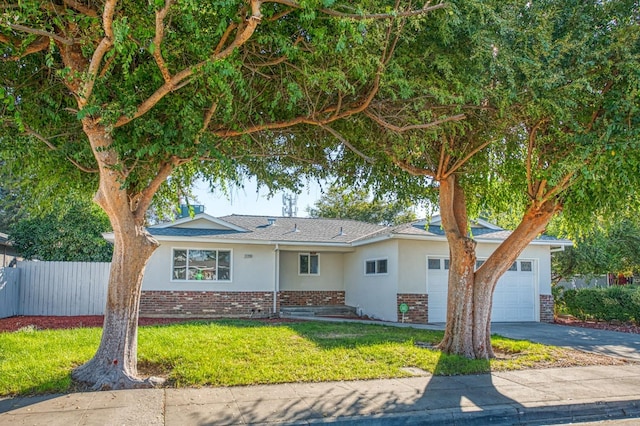 single story home with a garage and a front lawn