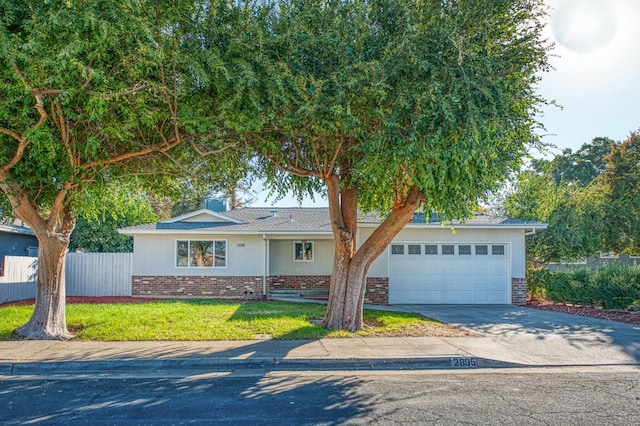 view of front of home with a garage and a front yard