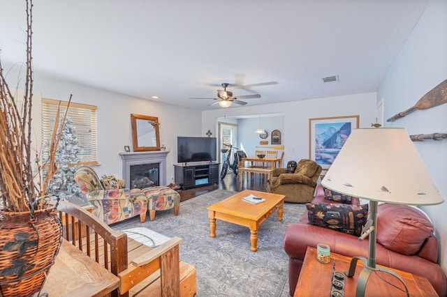 living room featuring hardwood / wood-style floors and ceiling fan