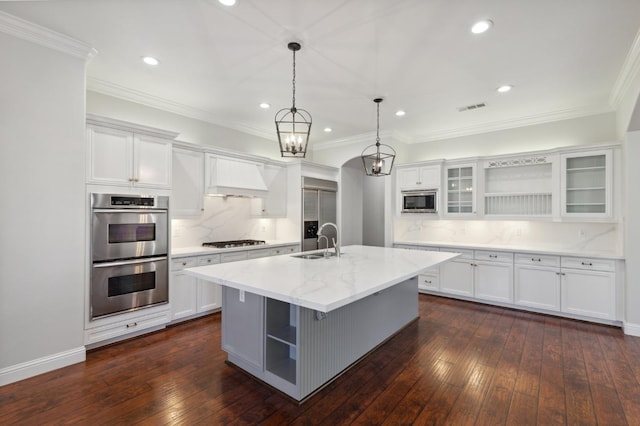 kitchen featuring white cabinets, dark hardwood / wood-style flooring, and a kitchen island with sink