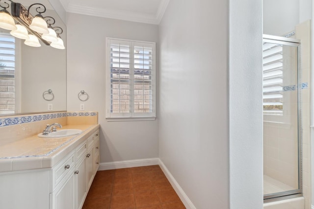 bathroom featuring vanity, ornamental molding, a shower with shower door, and tile patterned floors