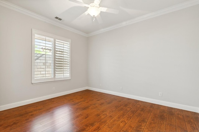 empty room featuring dark wood-type flooring, crown molding, and ceiling fan