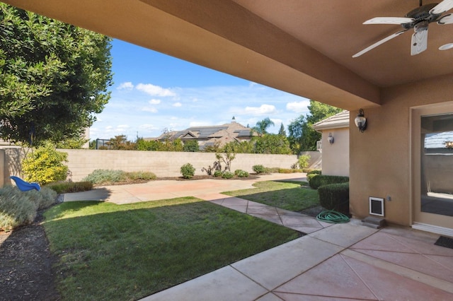 view of yard featuring ceiling fan and a patio area