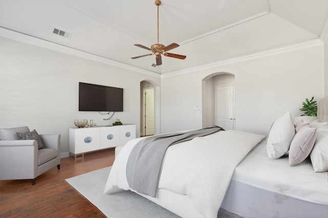 bedroom featuring ornamental molding, dark wood-type flooring, and ceiling fan