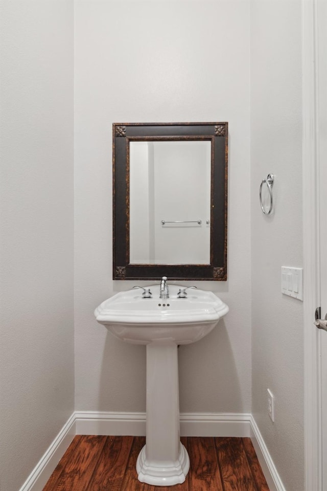 bathroom with sink and hardwood / wood-style flooring