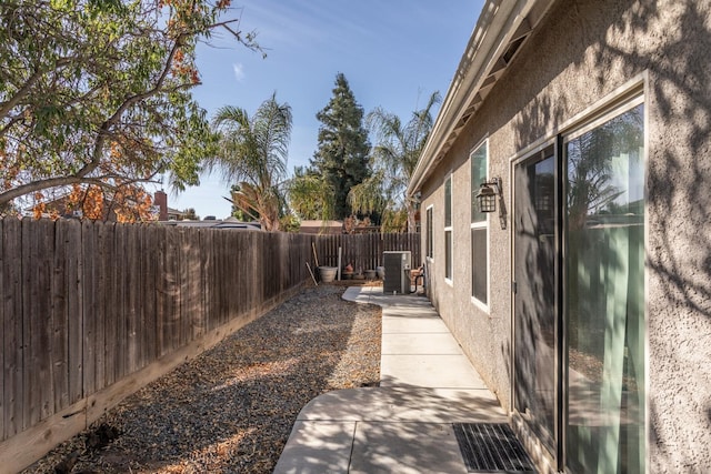 view of yard with a patio area, a fenced backyard, and central air condition unit