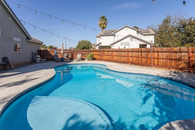 view of swimming pool with a fenced in pool, a fenced backyard, and a patio