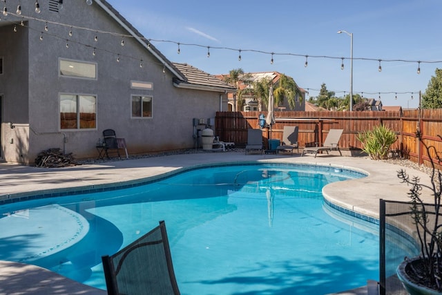 view of swimming pool featuring a fenced backyard, a fenced in pool, and a patio