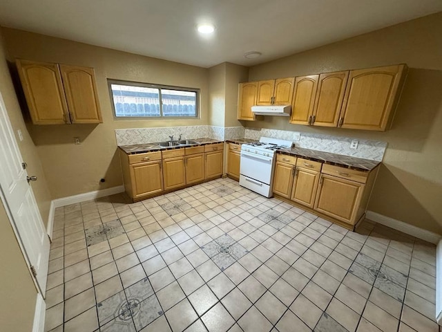 kitchen with light brown cabinetry, light tile patterned floors, and gas range gas stove