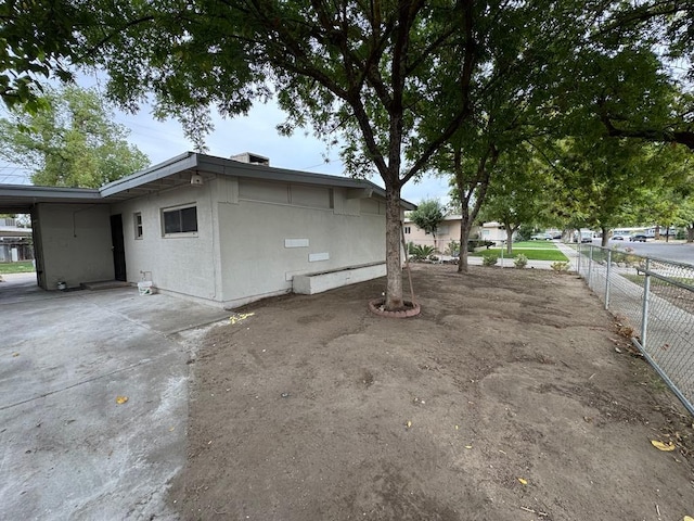view of property exterior featuring fence