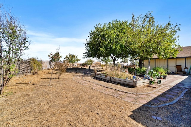 view of yard featuring a garden and fence