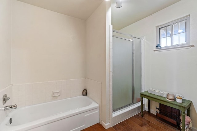 full bathroom with a garden tub, wood finished floors, and a shower stall