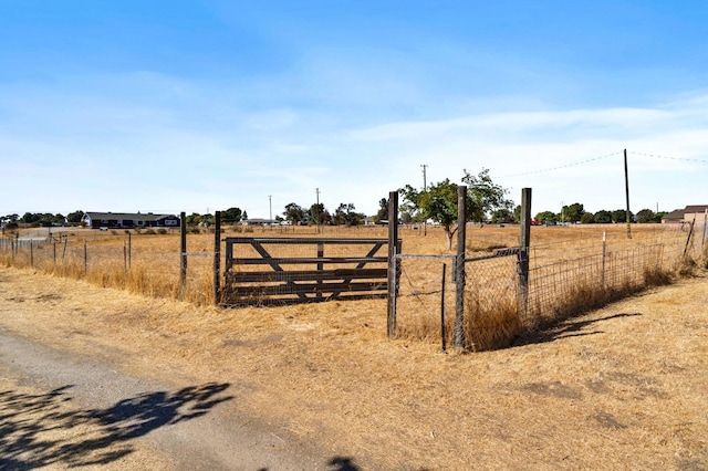 view of yard featuring fence and a rural view
