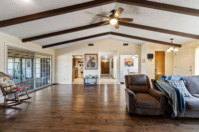 living room featuring lofted ceiling with beams, a textured ceiling, a ceiling fan, visible vents, and hardwood / wood-style flooring