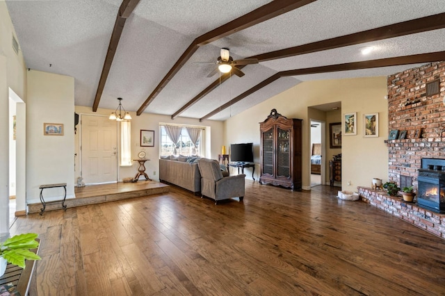 living room with ceiling fan, a textured ceiling, visible vents, hardwood / wood-style flooring, and vaulted ceiling with beams