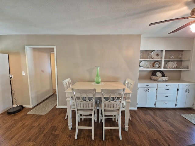 dining space with ceiling fan, dark hardwood / wood-style floors, and a textured ceiling