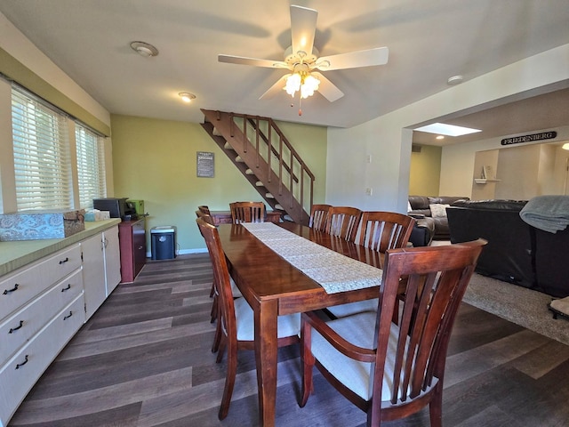 dining area featuring ceiling fan and dark hardwood / wood-style flooring