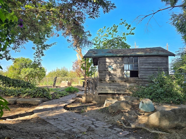 view of side of home featuring an outbuilding