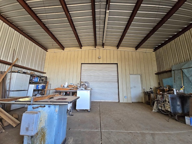 garage with a workshop area and wood walls