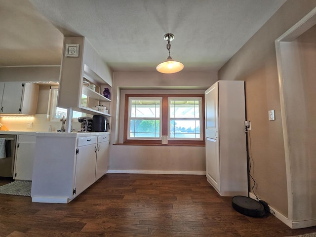 kitchen with pendant lighting, dishwasher, dark wood-type flooring, and white cabinets