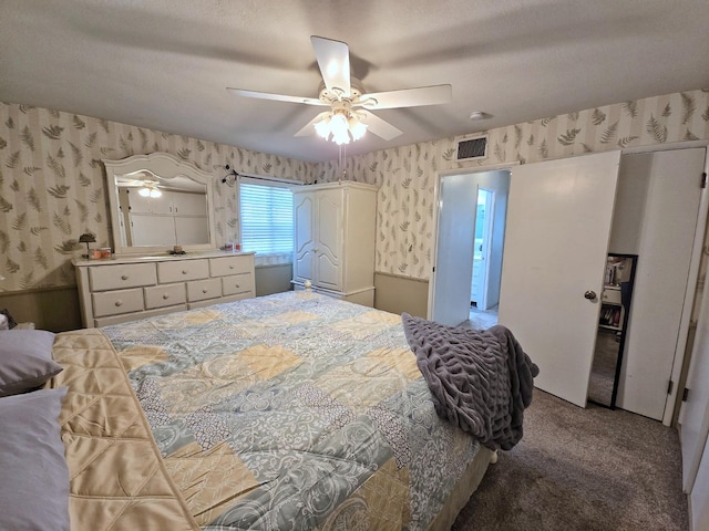 bedroom featuring carpet, a textured ceiling, and ceiling fan