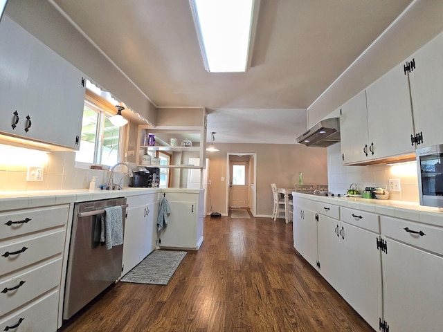 kitchen with white cabinetry, stainless steel dishwasher, tile countertops, and tasteful backsplash