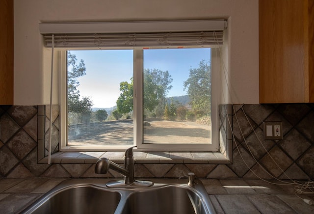 room details featuring decorative backsplash and sink