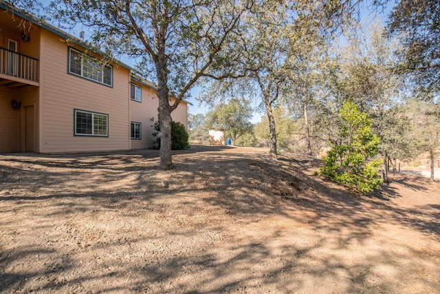 view of yard featuring a balcony